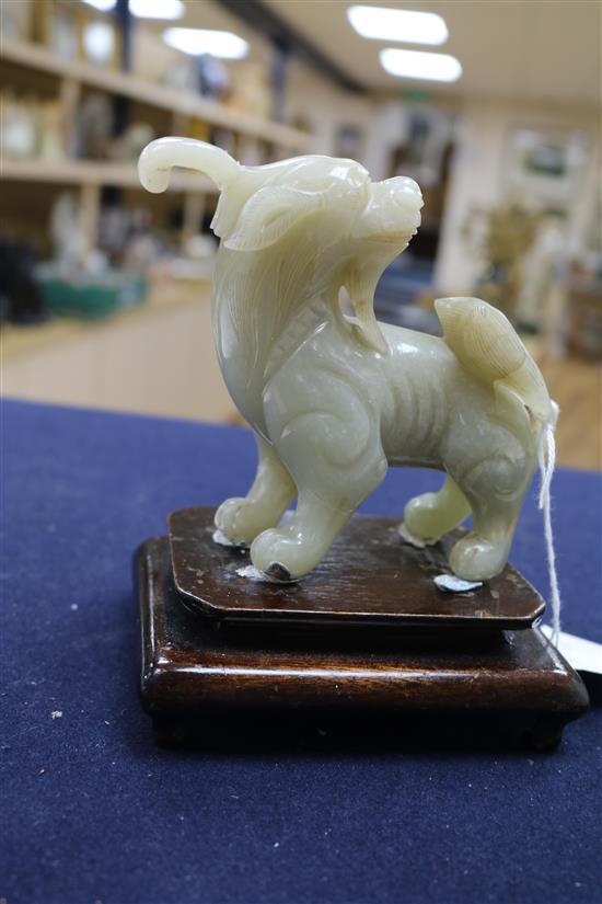 Two Chinese celadon jade figures of a fisherman and a lion-dog, 6.2 and 11cm, wood stands